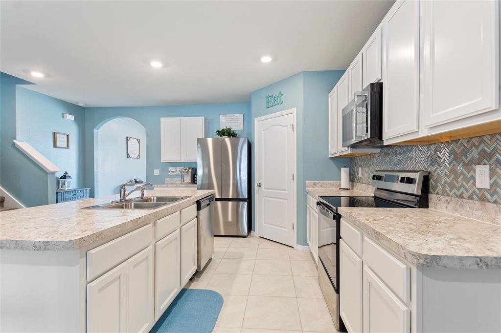 856 Sun Burst Road Winter Haven, FL 33880 - Photo 8 of 54 a kitchen with a sink stove and refrigerator