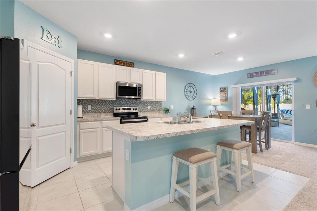 856 Sun Burst Road Winter Haven, FL 33880 - Photo 10 of 54 a kitchen with a refrigerator and a stove top oven