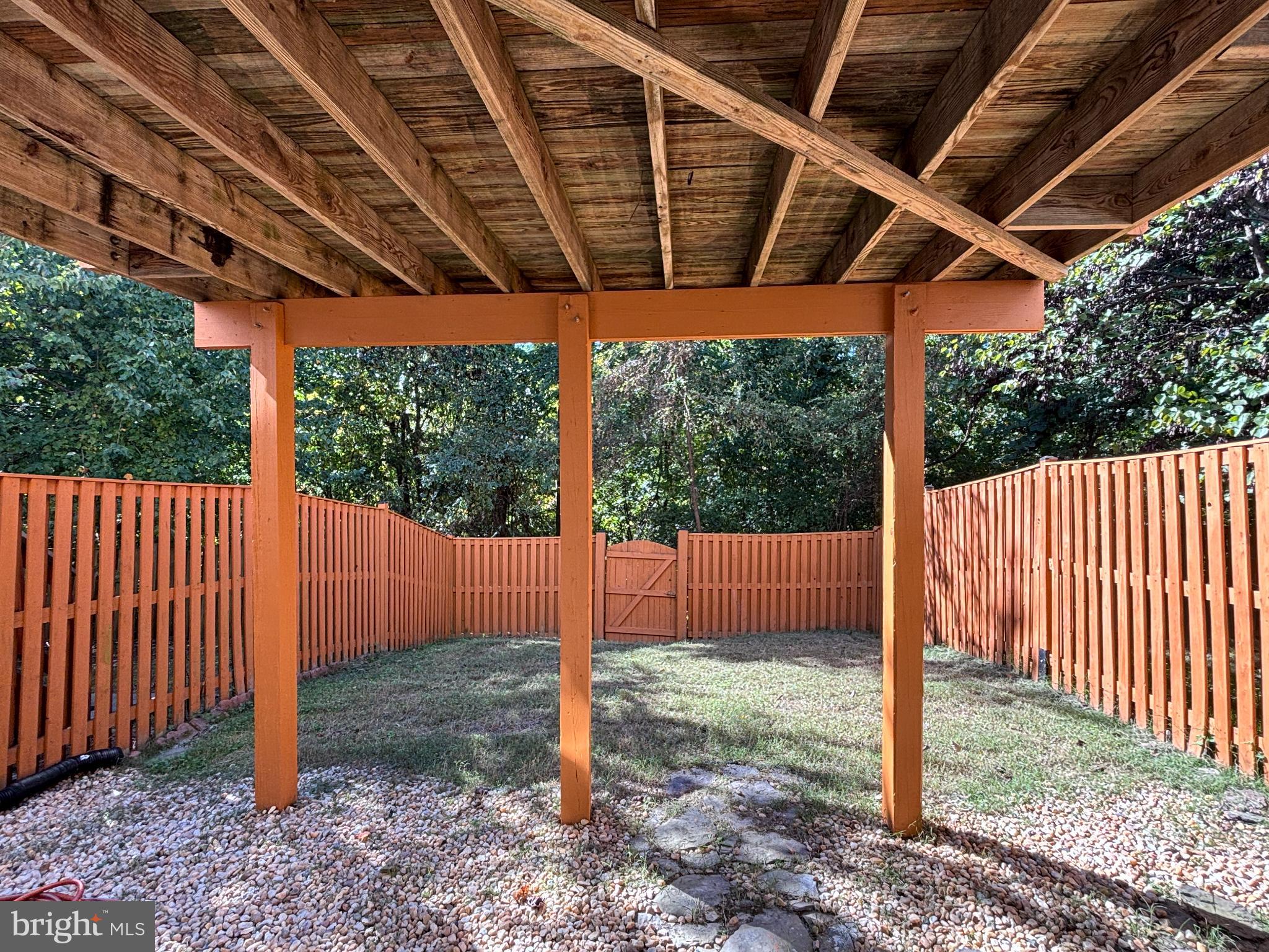15656 Avocet Loop Woodbridge, VA 22191 - Photo 27 of 28 a backyard of a house with a tub and wooden fence