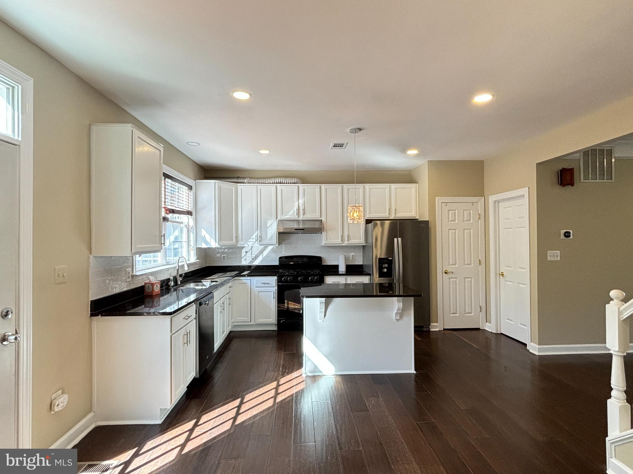 15656 Avocet Loop Woodbridge, VA 22191 - Photo 7 of 28 a kitchen with a sink a refrigerator and cabinets
