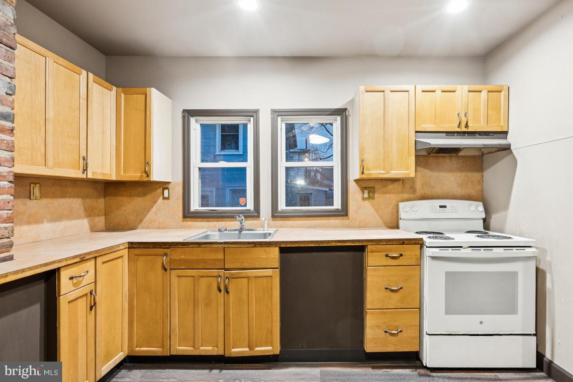 709 Buck Street Millville, NJ 08332 - Photo 11 of 20 a kitchen with a sink stove and cabinets