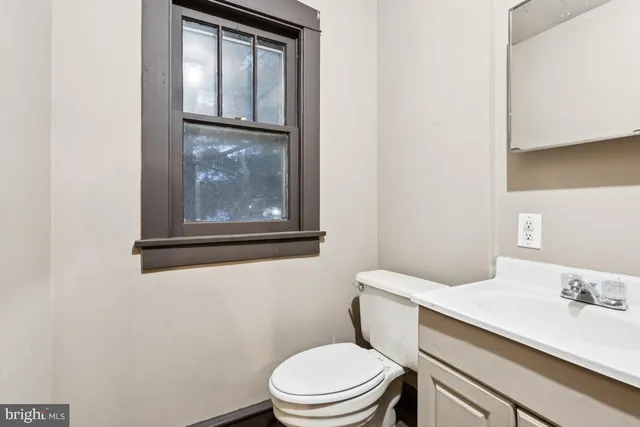 a bathroom with a sink a toilet a shower and a mirror