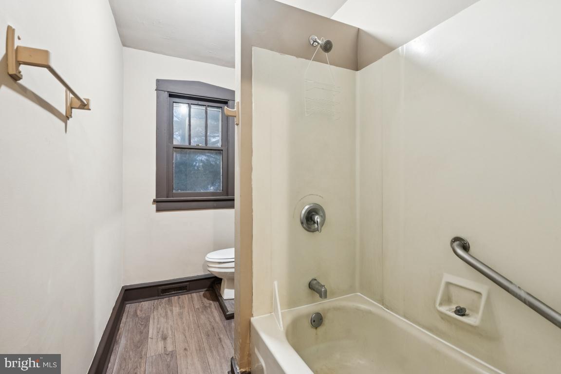 709 Buck Street Millville, NJ 08332 - Photo 17 of 20 a bathroom with a sink a toilet a shower and a mirror