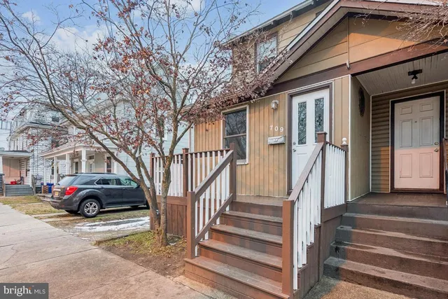 a view of a car park in front of a house