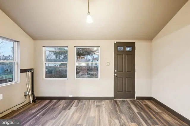 a large kitchen with stainless steel appliances granite countertop a stove and a large window