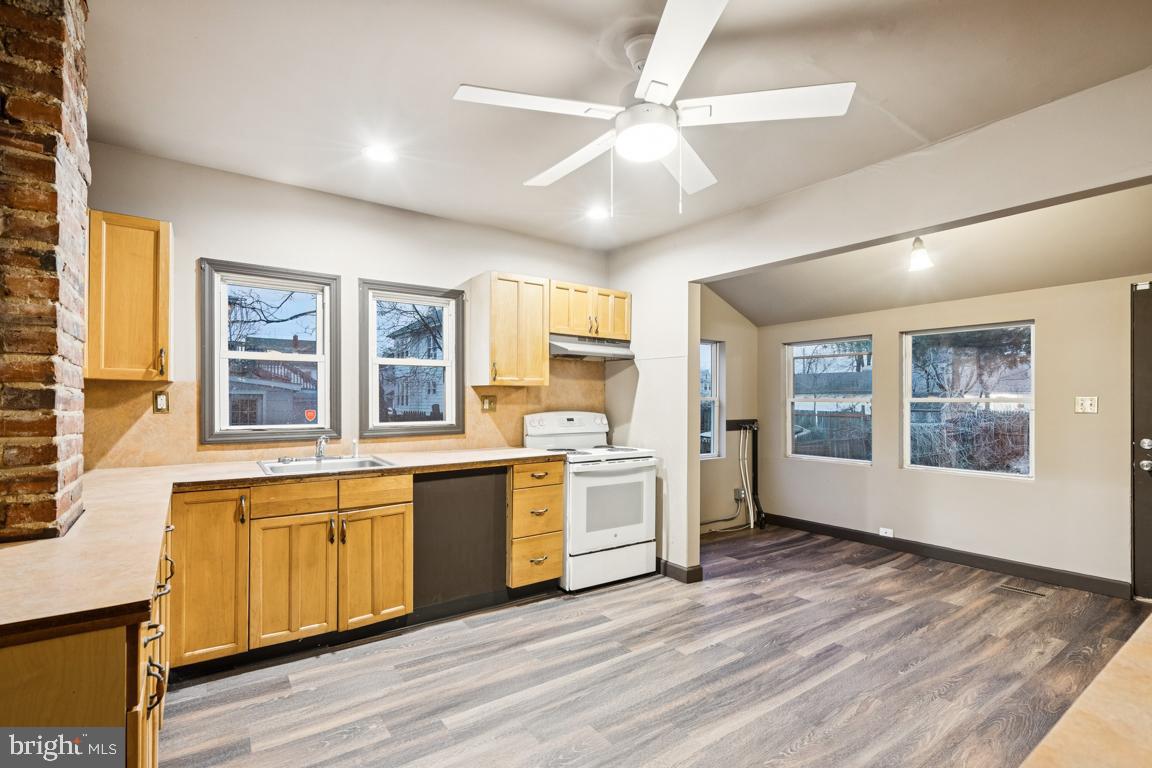 709 Buck Street Millville, NJ 08332 - Photo 9 of 20 a large kitchen with stainless steel appliances granite countertop a stove and a large window