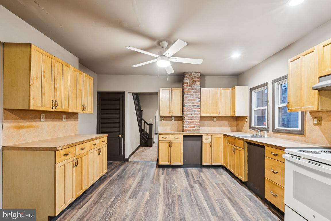 709 Buck Street Millville, NJ 08332 - Photo 10 of 20 a kitchen with a stove a sink and a refrigerator