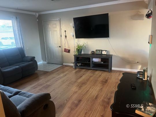 133 South Locust Street Ridgecrest, CA 93555 - Photo 10 of 26 a living room with furniture and a flat screen tv