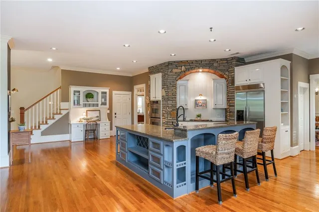 a bathroom with a granite countertop sink toilet and mirror