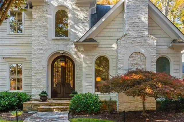a front view of a house with garden