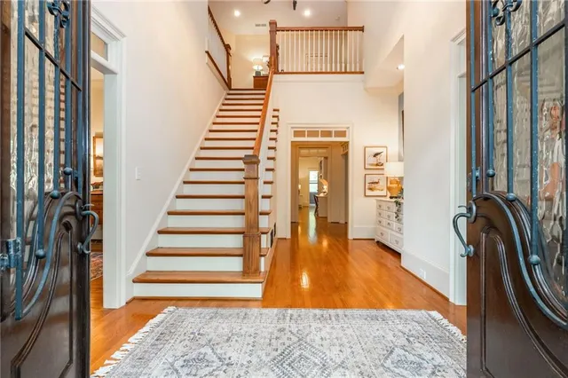 a living room with stainless steel appliances granite countertop furniture wooden floor and a kitchen view