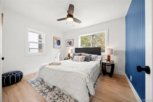 a bedroom with a bed and wooden floor