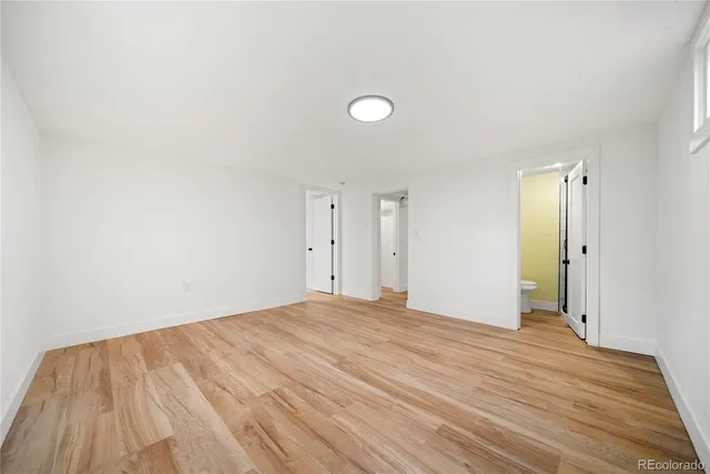 a view of empty room with wooden floor