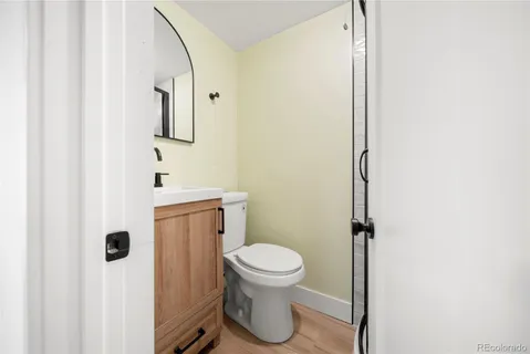 a bathroom with a toilet a sink and mirror