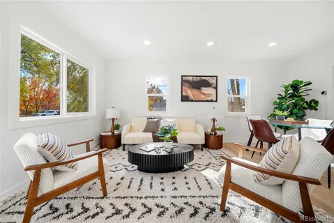 a living room with furniture potted plant and window