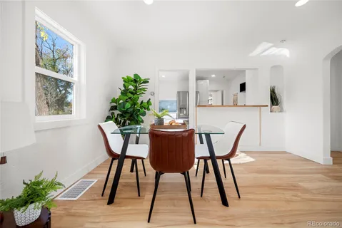a dining room with furniture and wooden floor