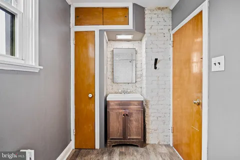 a bathroom with a sink and mirror with shower
