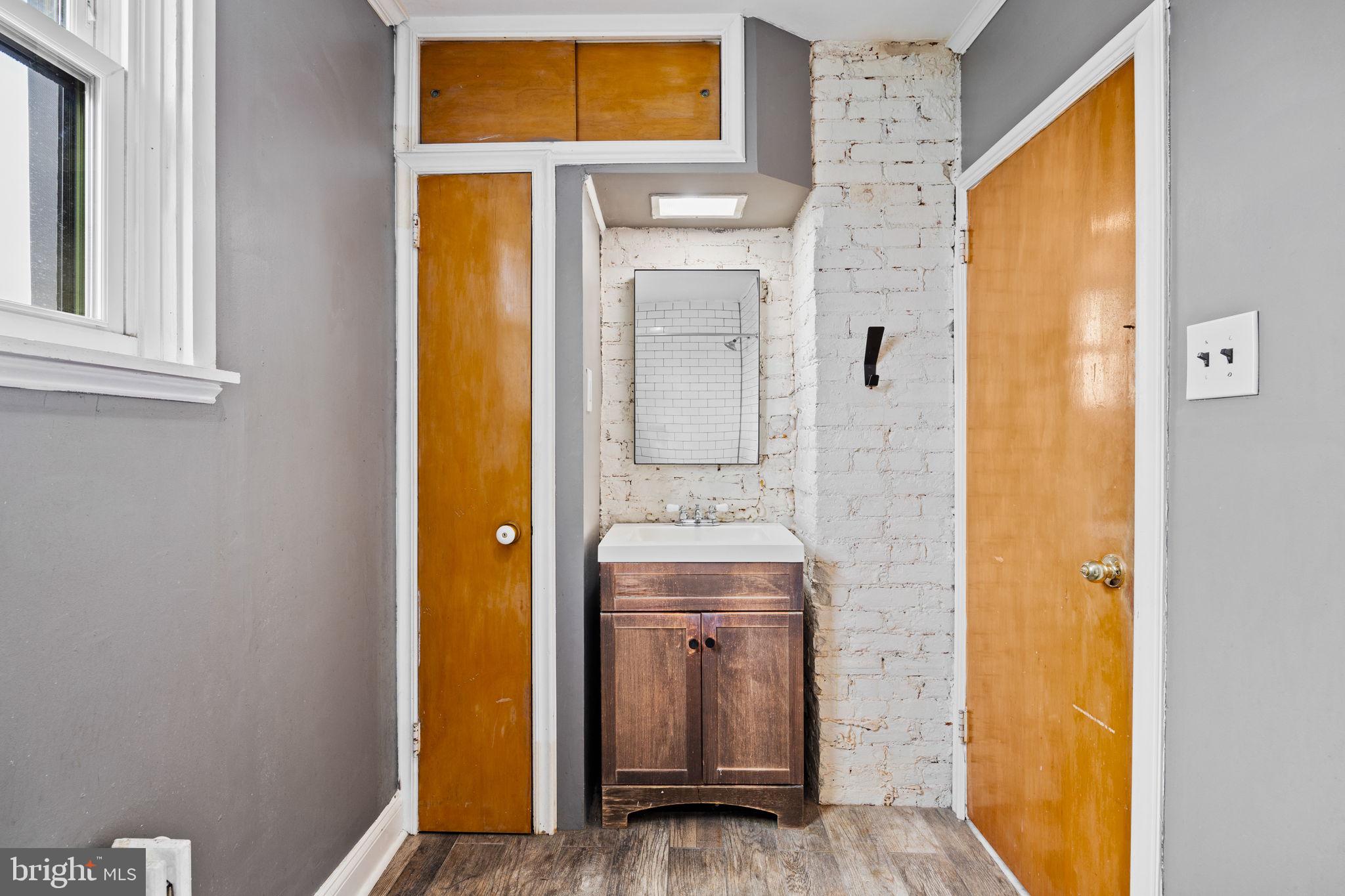 3138 Miller Street Philadelphia, PA 19134 - Photo 23 of 30 a bathroom with a sink and mirror with shower