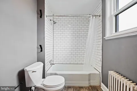 a bathroom with a toilet and a bathtub