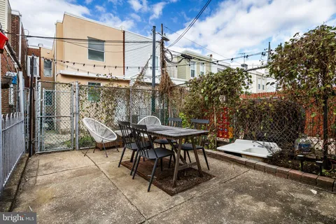a view of a patio with a table and chairs