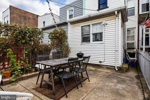 a view of a patio with table and chairs and potted plants