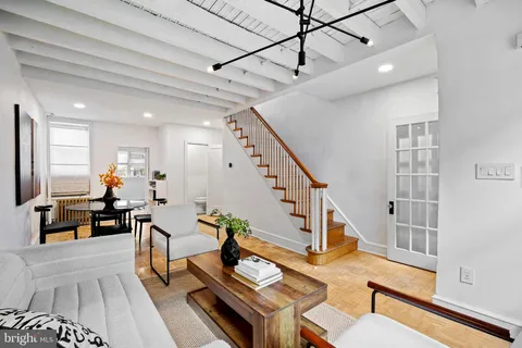 a living room with furniture dining table and a flat screen tv
