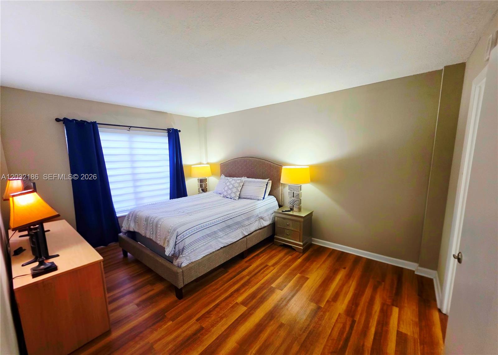 4164 Inverrary Drive, Unit 204 Lauderhill, FL 33319 - Photo 5 of 28 a bedroom with a bed and lamp on table