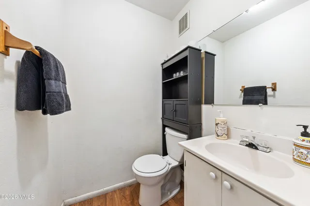 a bathroom with a sink toilet and mirror