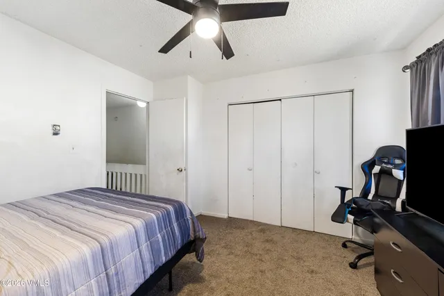 a bedroom with a bed and a desk