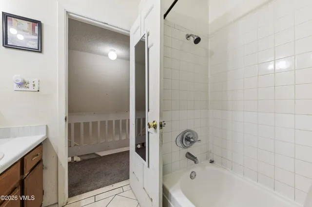 a bathroom with a bathtub and shower