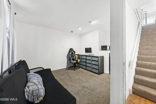 a bed room with a bed and a chair