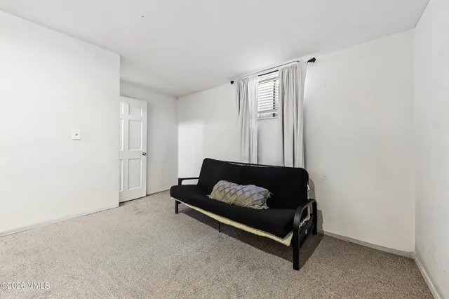 a living room with furniture and a air conditioner vent