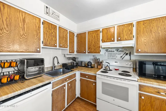 a kitchen with stainless steel appliances a stove a sink and a microwave