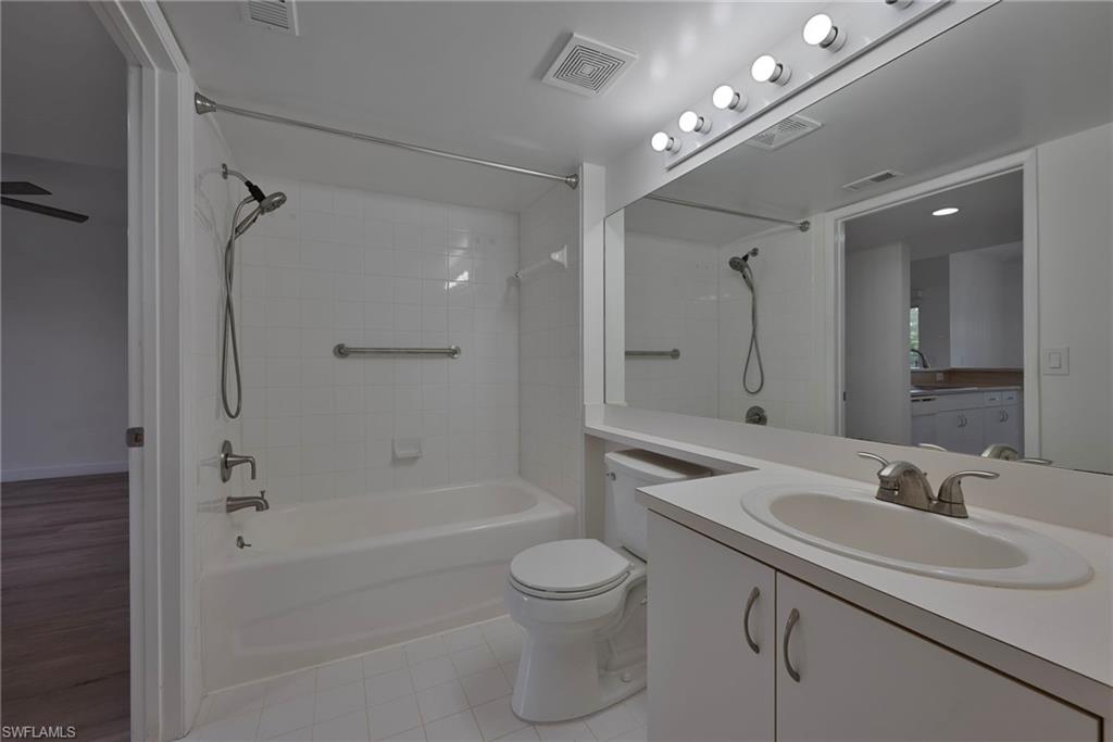 1885 Florida Club Drive, Unit 8305 Naples, FL 34112 - Photo 11 of 22 Full bathroom with tub / shower combination, vanity, and light tile patterned flooring