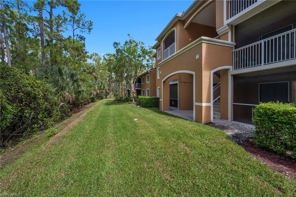 1885 Florida Club Drive, Unit 8305 Naples, FL 34112 - Photo 2 of 22 View of grassy yard featuring a balcony