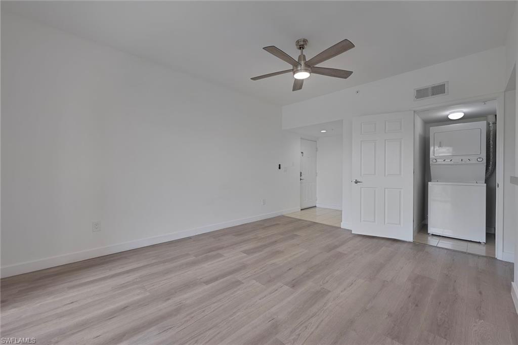1885 Florida Club Drive, Unit 8305 Naples, FL 34112 - Photo 4 of 22 Unfurnished living room with light wood-style floors, and a ceiling fan