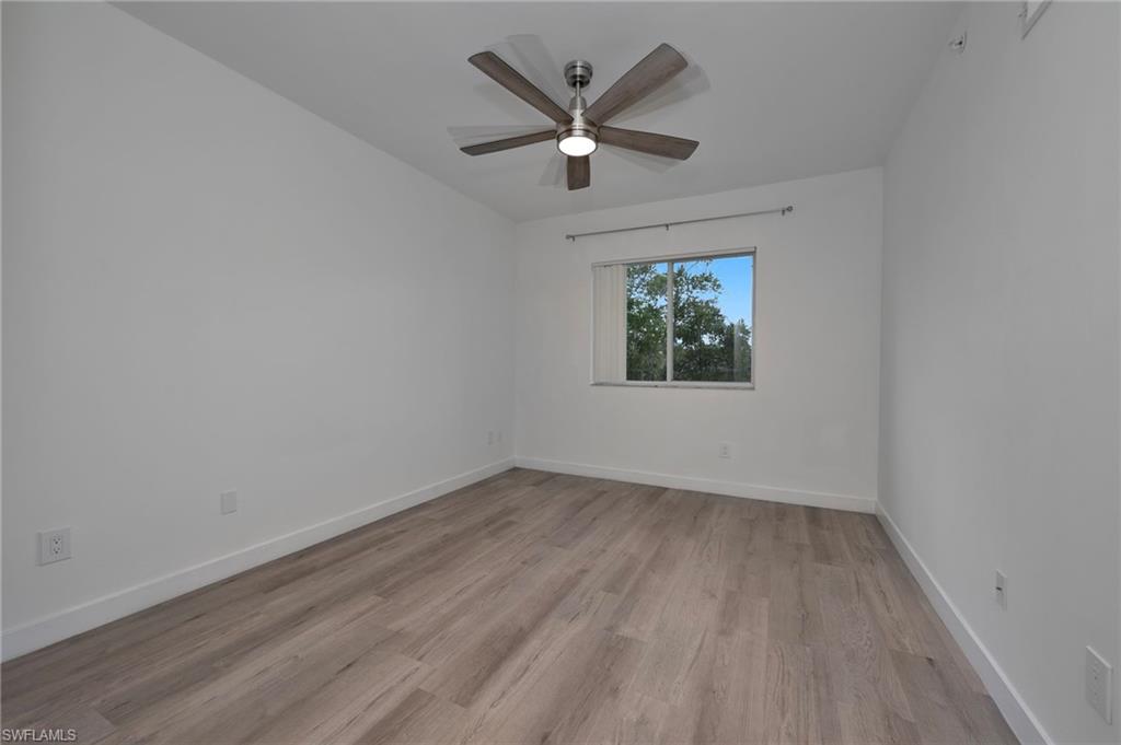 1885 Florida Club Drive, Unit 8305 Naples, FL 34112 - Photo 9 of 22 Bedroom featuring light wood-style floors and ceiling fan