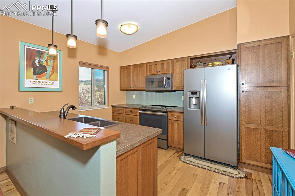 1142 Fontmore Road, Unit C Colorado Springs, CO 80904 - Photo 13 of 33 a kitchen with granite countertop a refrigerator and a sink