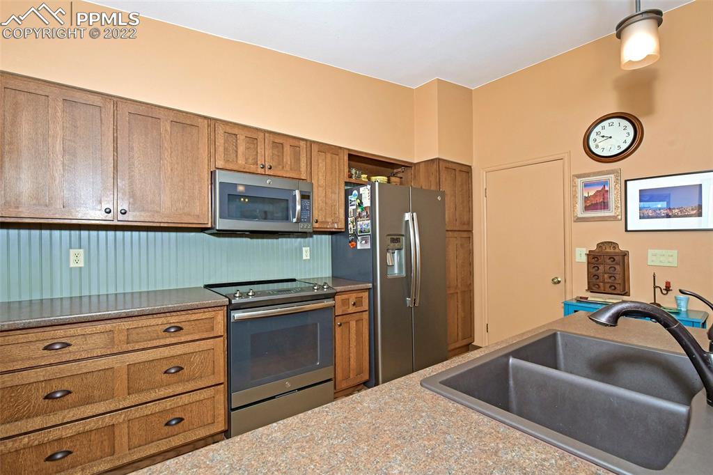 1142 Fontmore Road, Unit C Colorado Springs, CO 80904 - Photo 14 of 33 a kitchen with stainless steel appliances granite countertop a refrigerator and a sink