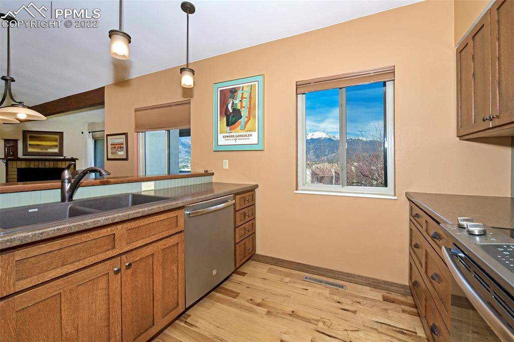 1142 Fontmore Road, Unit C Colorado Springs, CO 80904 - Photo 15 of 33 a kitchen with stainless steel appliances granite countertop a sink a stove and a wooden floors
