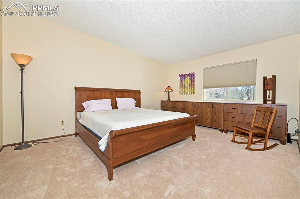 1142 Fontmore Road, Unit C Colorado Springs, CO 80904 - Photo 16 of 33 a bedroom with a bed chair and a window