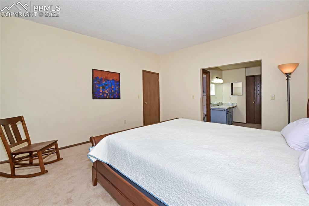 1142 Fontmore Road, Unit C Colorado Springs, CO 80904 - Photo 17 of 33 a bedroom with a bed and chair