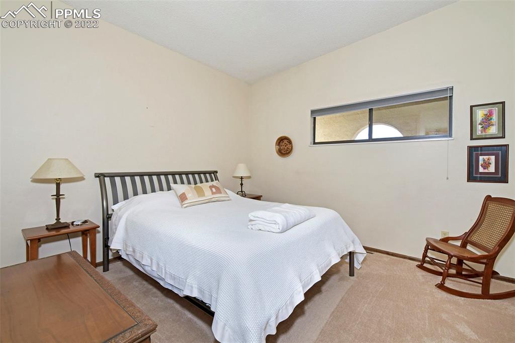 1142 Fontmore Road, Unit C Colorado Springs, CO 80904 - Photo 19 of 33 a bedroom with a bed and chair