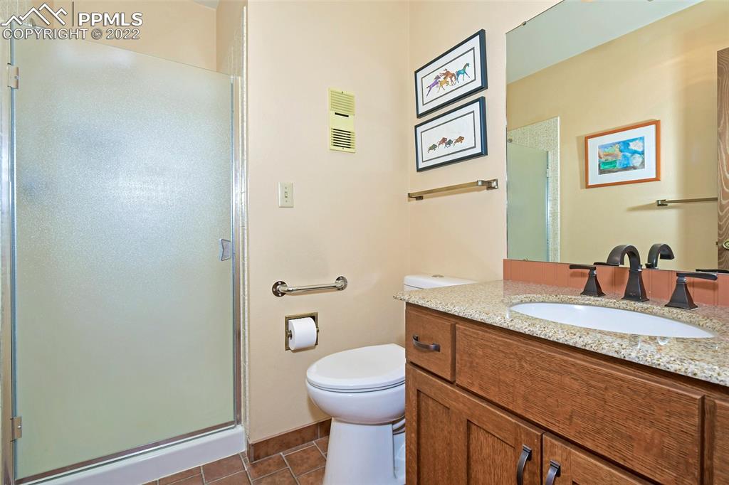 1142 Fontmore Road, Unit C Colorado Springs, CO 80904 - Photo 20 of 33 a bathroom with a granite countertop toilet sink and mirror
