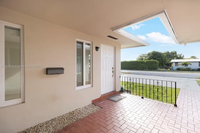 a view of a porch with wooden floor and fence