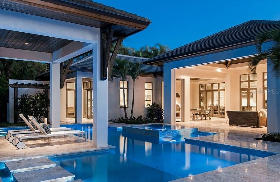 5215 Hidden Harbor Road Sarasota, FL 34242 - Photo 10 of 22 a living room with furniture a wooden floor and a large window