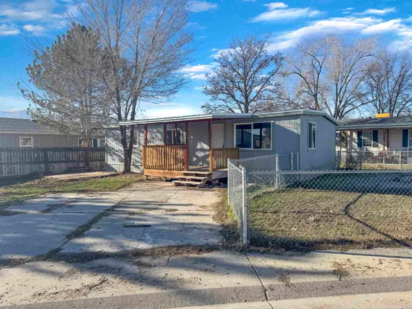 a view of a house with snow on the road