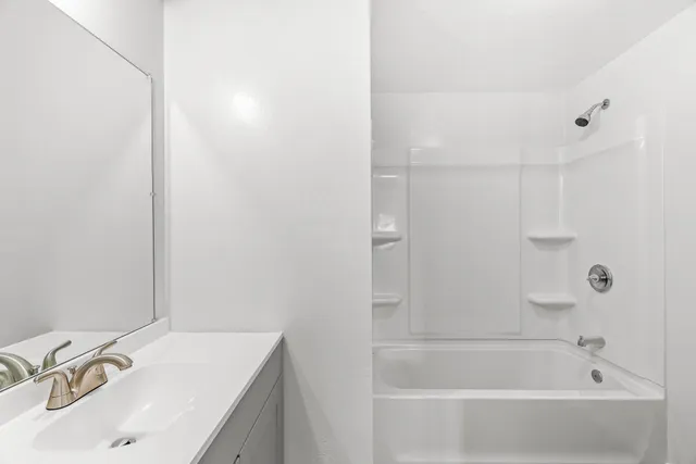 a white bath tub sitting next to a white sink