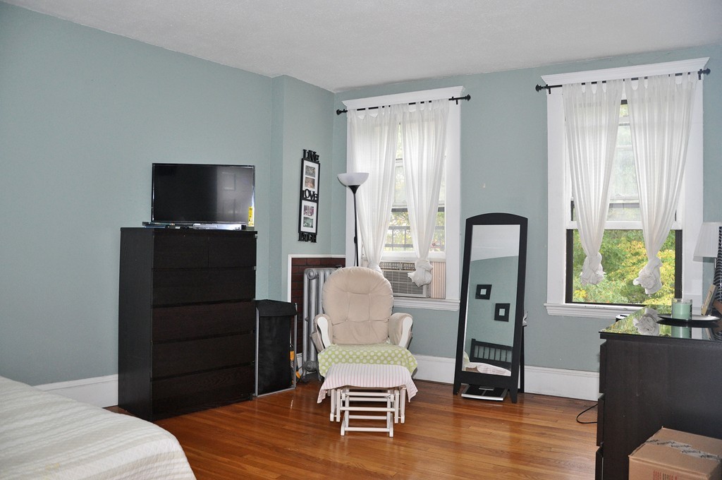 30 Kinross Road, Unit 12 Boston, MA 02135 - Photo 6 of 11 a living room with furniture and a flat screen tv