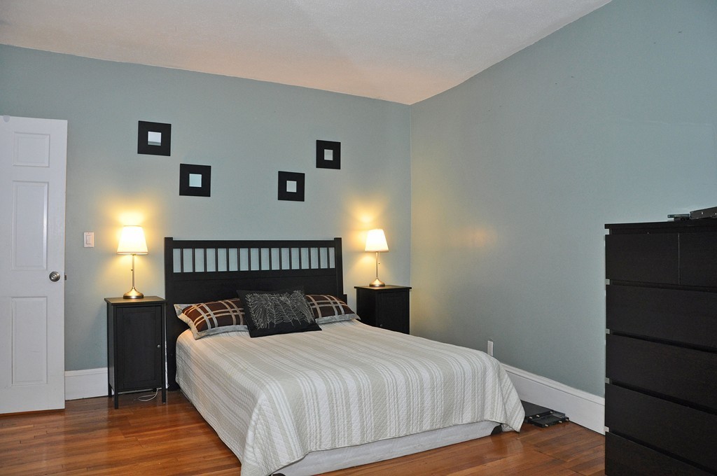 30 Kinross Road, Unit 12 Boston, MA 02135 - Photo 7 of 11 a bedroom with a bed and wooden floor
